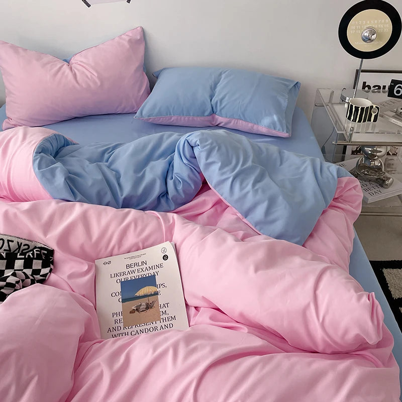 Bed with pink and blue bedding, a book titled 'Berlin' on the pillow, and a nightstand with decor items.