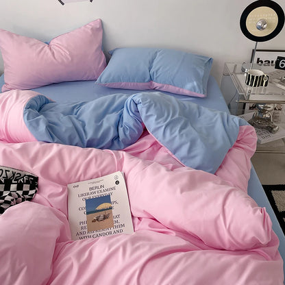Bed with pink and blue bedding, a book titled 'Berlin' on the pillow, and a nightstand with decor items.