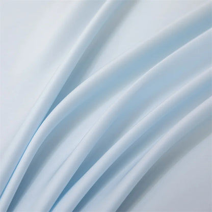 Close-up of light blue fabric with soft folds