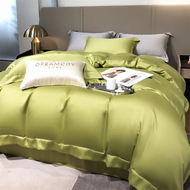 Green bedding set on a bed with 'Dreamcity Home' branding, in a bedroom setting.