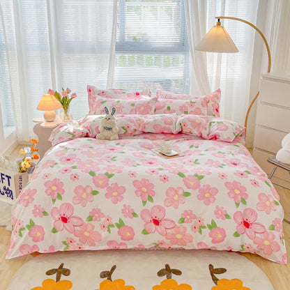 Floral bedding set on a bed in a bright bedroom with white curtains.