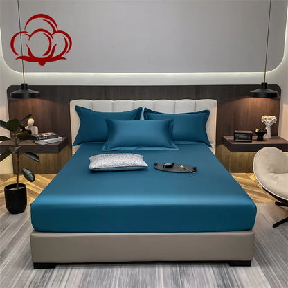 Modern bedroom with a bed featuring dark blue bedding and a decorative headboard.