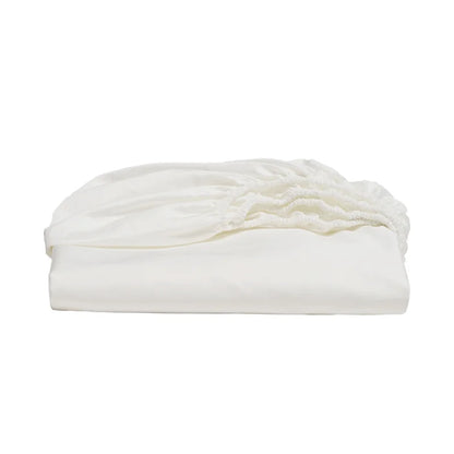 Folded white comforter on a white background