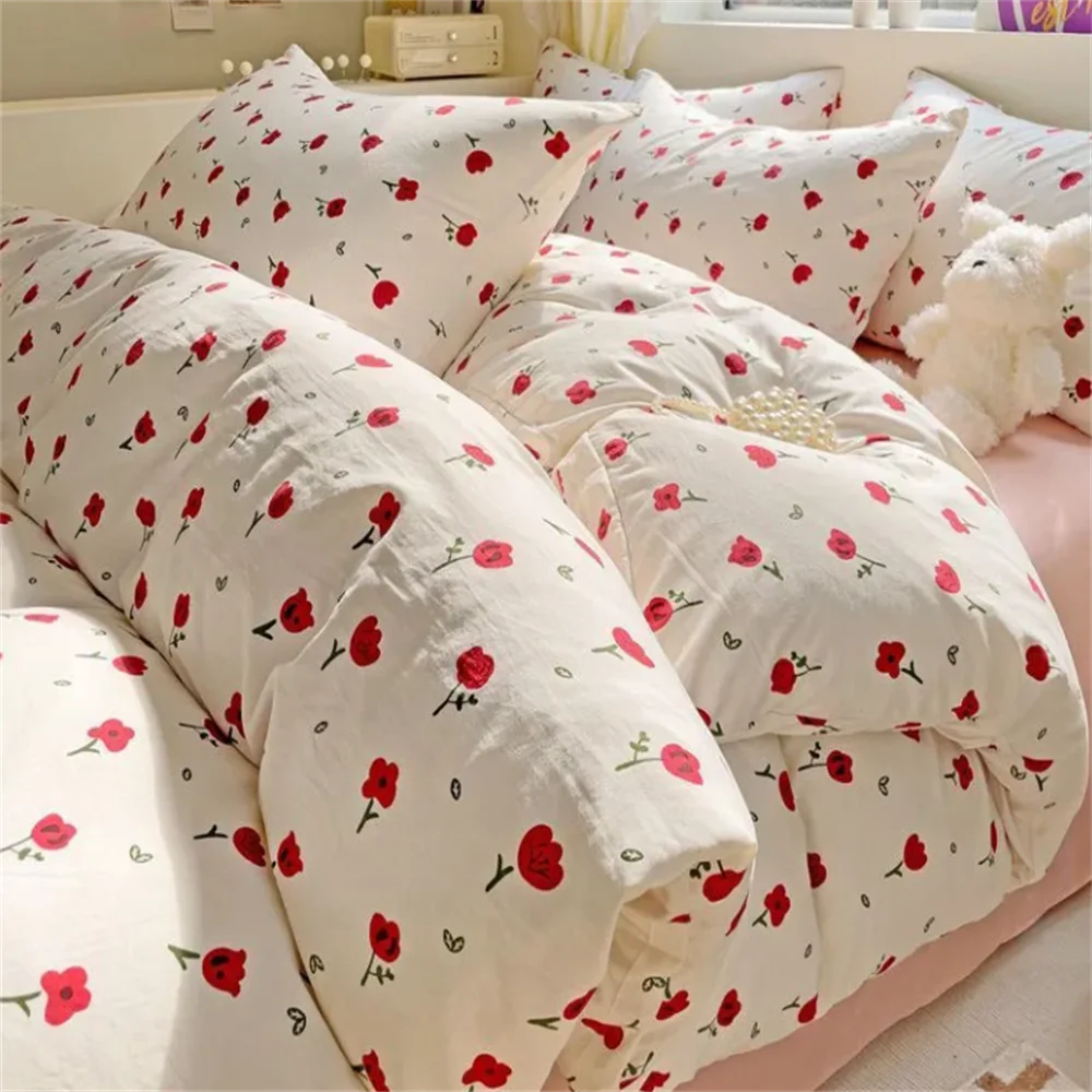 Floral patterned comforter on a bed with pillows