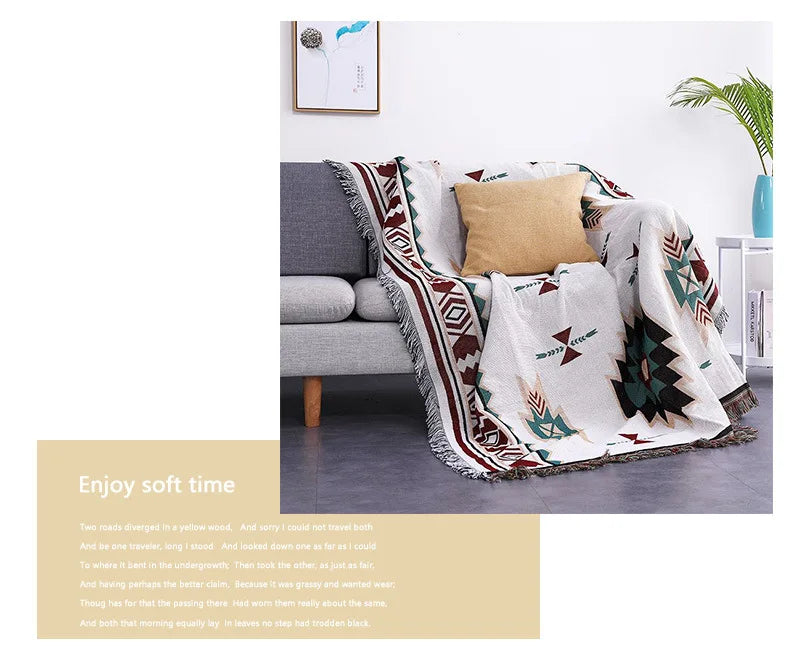 Decorative blanket with geometric pattern draped over a sofa in a living room setting.