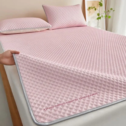 Pink mattress topper on a bed with text 'A beanie mattress topper for sleeping naked'.