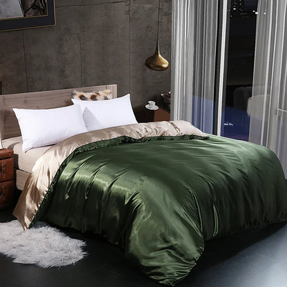 Green satin comforter on a bed in a modern bedroom setting.