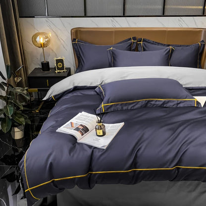Navy blue bedding set with gold trim on a bed in a bedroom setting.