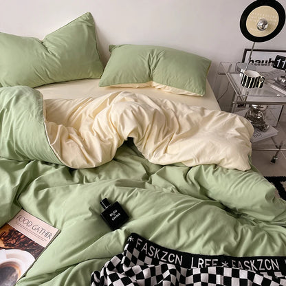 Green bedding set with a bottle of perfume and checkered pants on a bed.