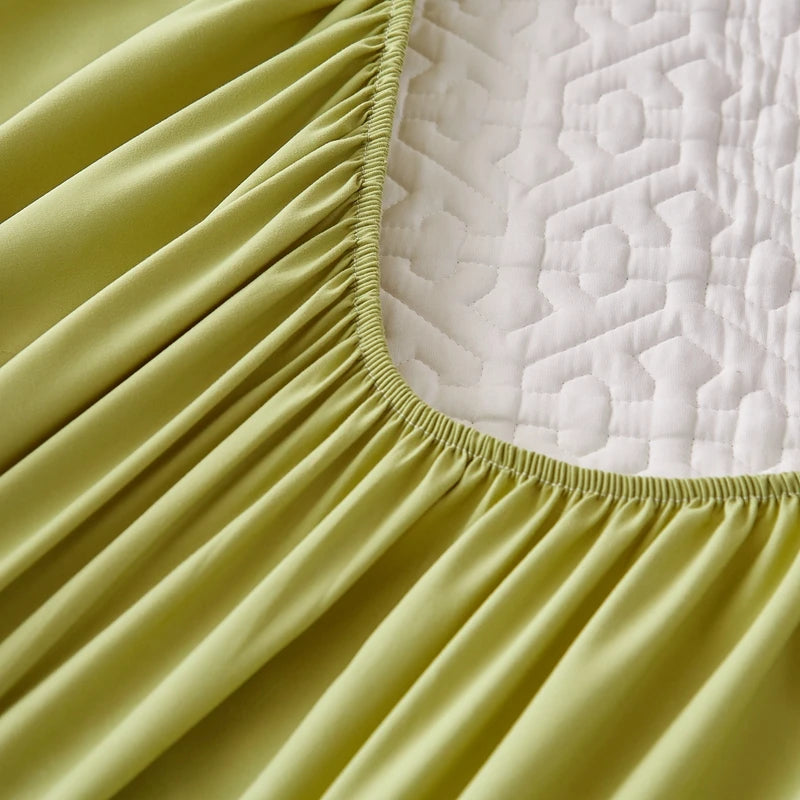 Close-up of a yellow fitted sheet on a mattress with a textured surface.