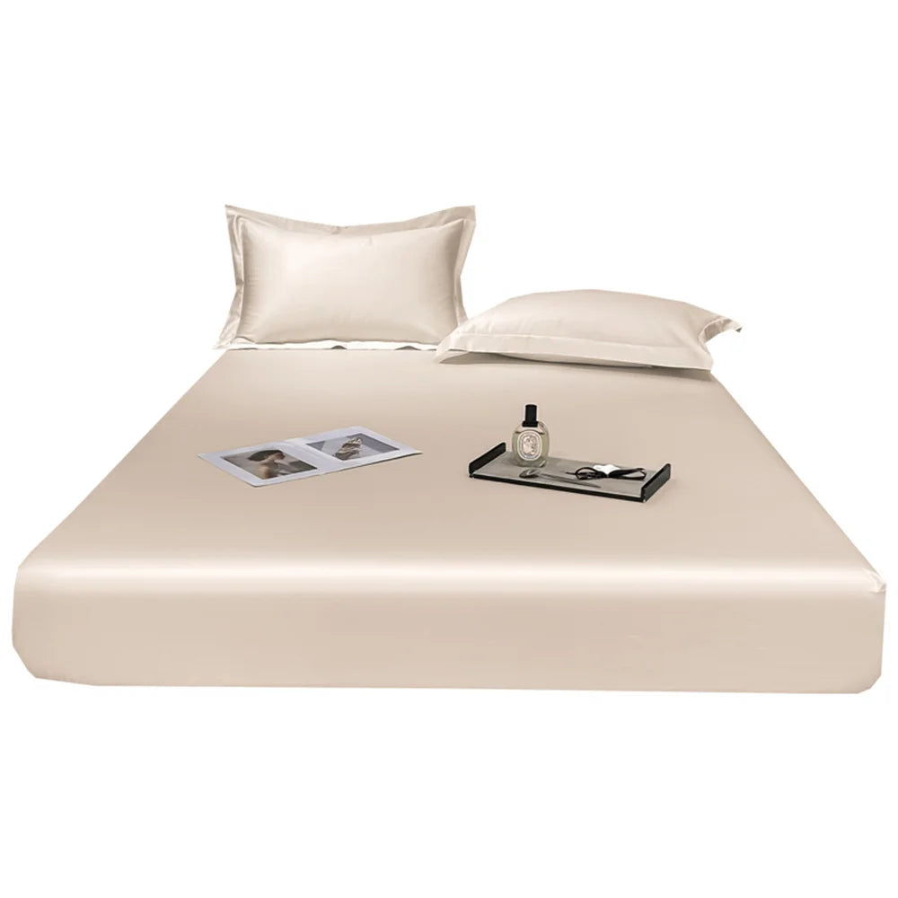 Beige satin sheet set with pillows and a tray on a white background