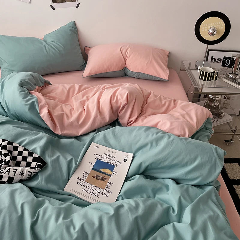 Bed with pink and teal bedding, a book titled 'Berlin' on the bed, and a nightstand with decorative items.