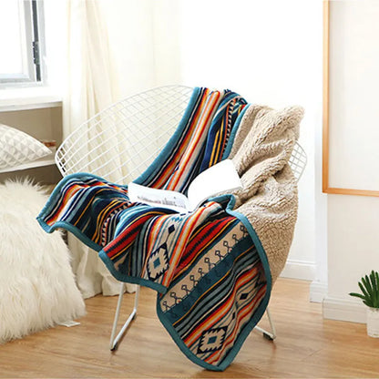 Colorful patterned blanket draped over a chair in a room with light decor