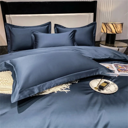 Navy blue bedding set on a bed with a lamp and magazine in the background.