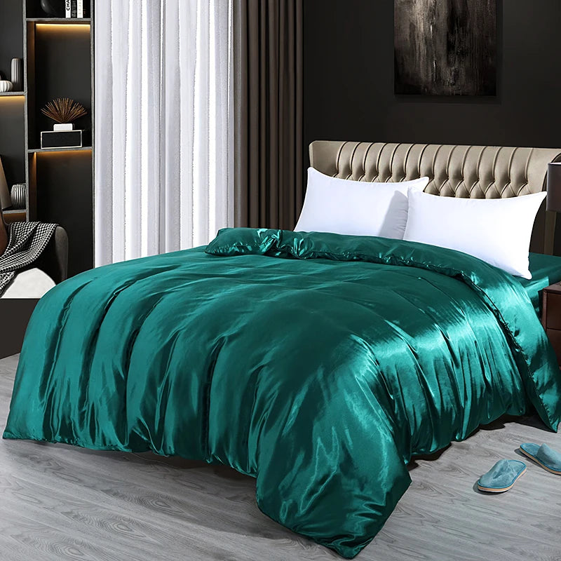 Teal satin comforter set on a bed in a bedroom with a dark wall and white curtains.