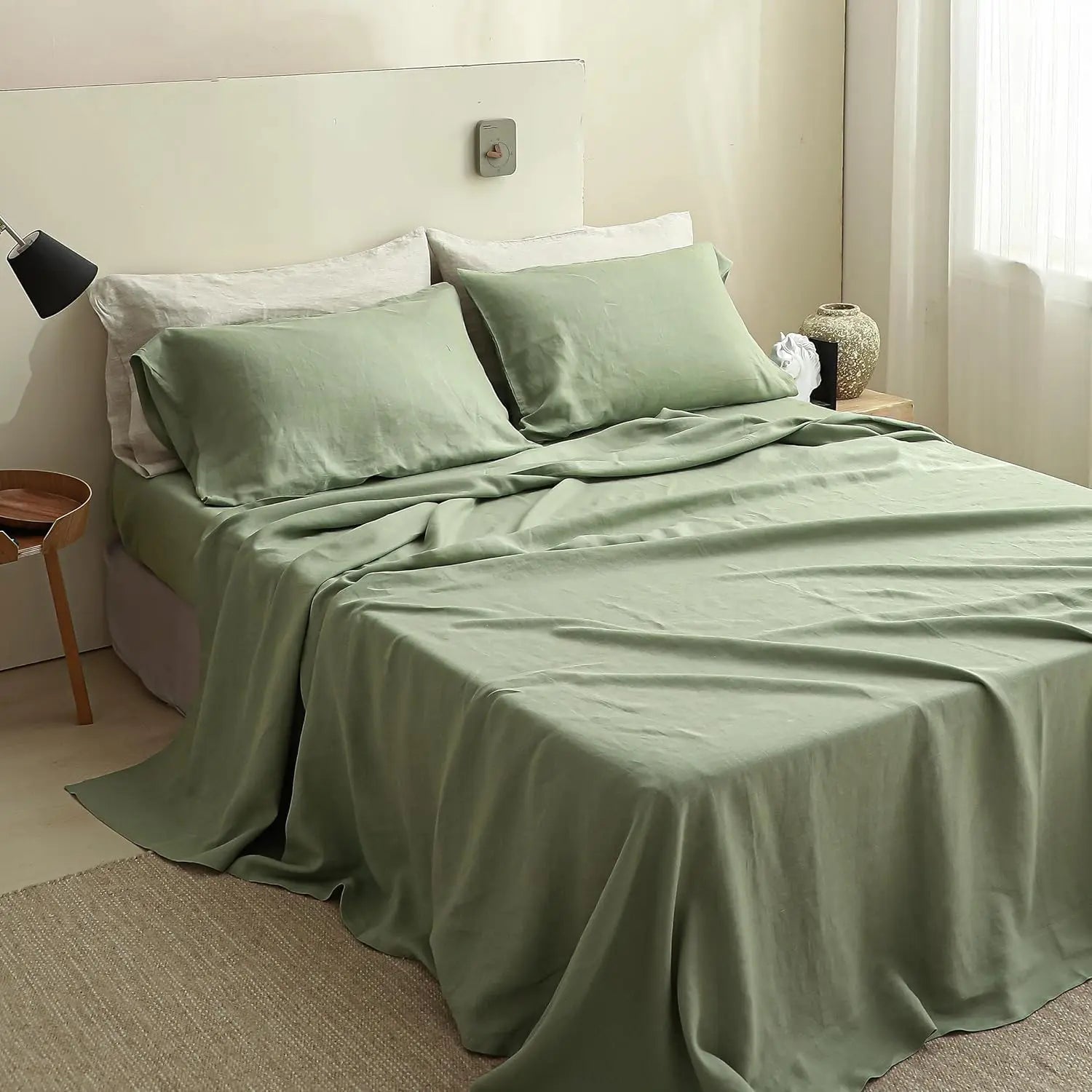 Bed with green bedding in a bedroom setting