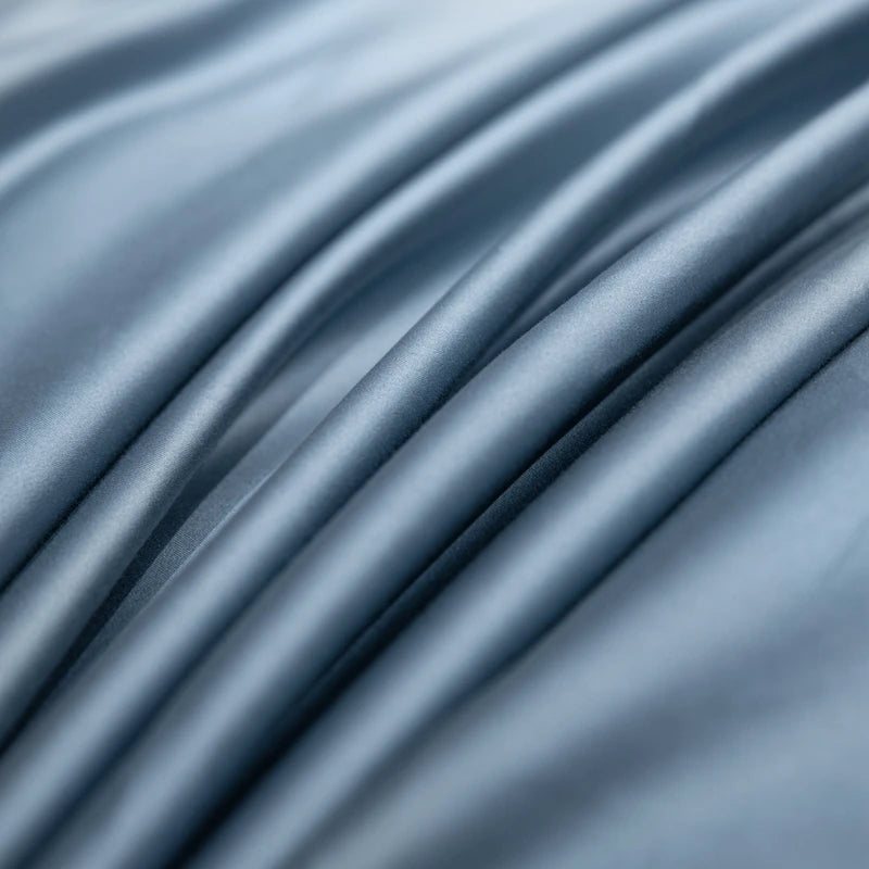 Close-up of blue satin fabric with folds