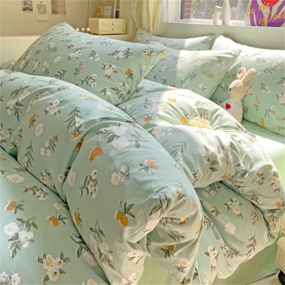 Floral patterned bedding set on a bed with a stuffed rabbit toy.