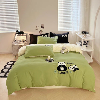 Bedroom with green bedding featuring panda bears and 'Lucky' text.