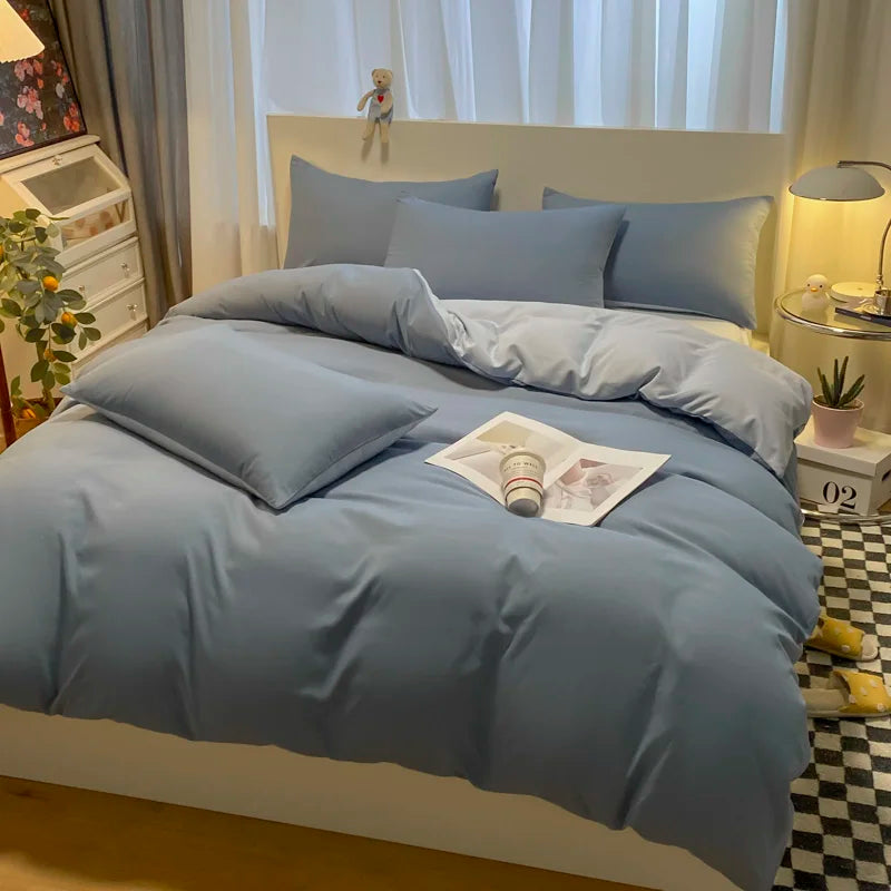Bed with blue bedding in a bedroom setting