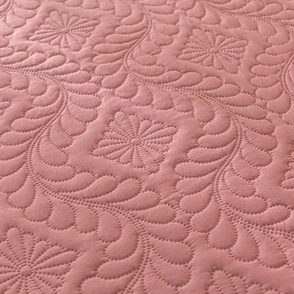 Close-up of pink quilted fabric with a floral pattern
