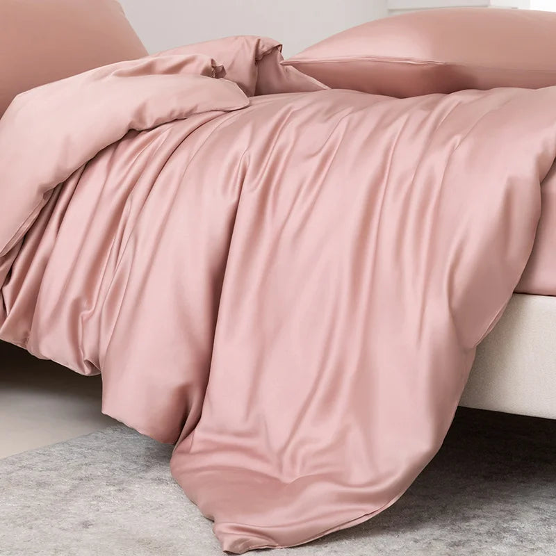 Pink bedding set on a bed with a neutral background