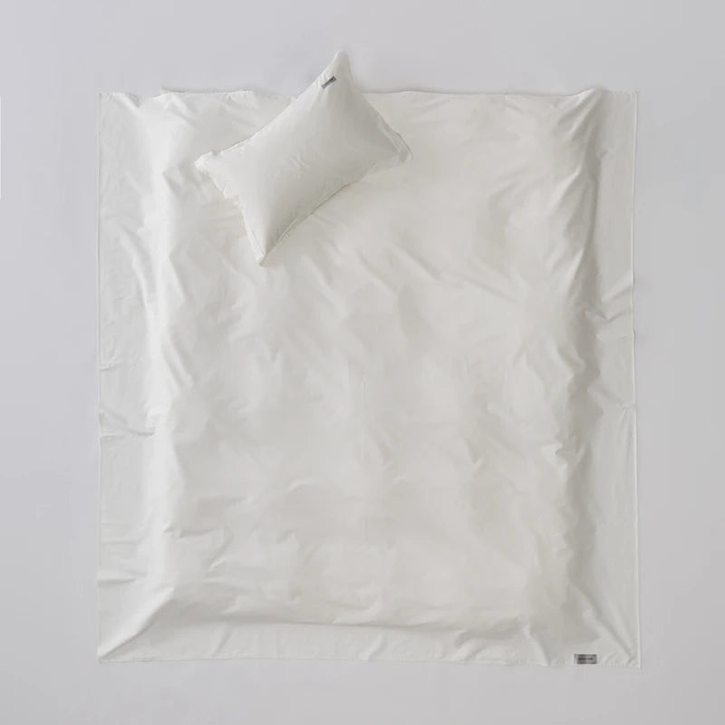 White pillowcase with a pillow on a light gray background