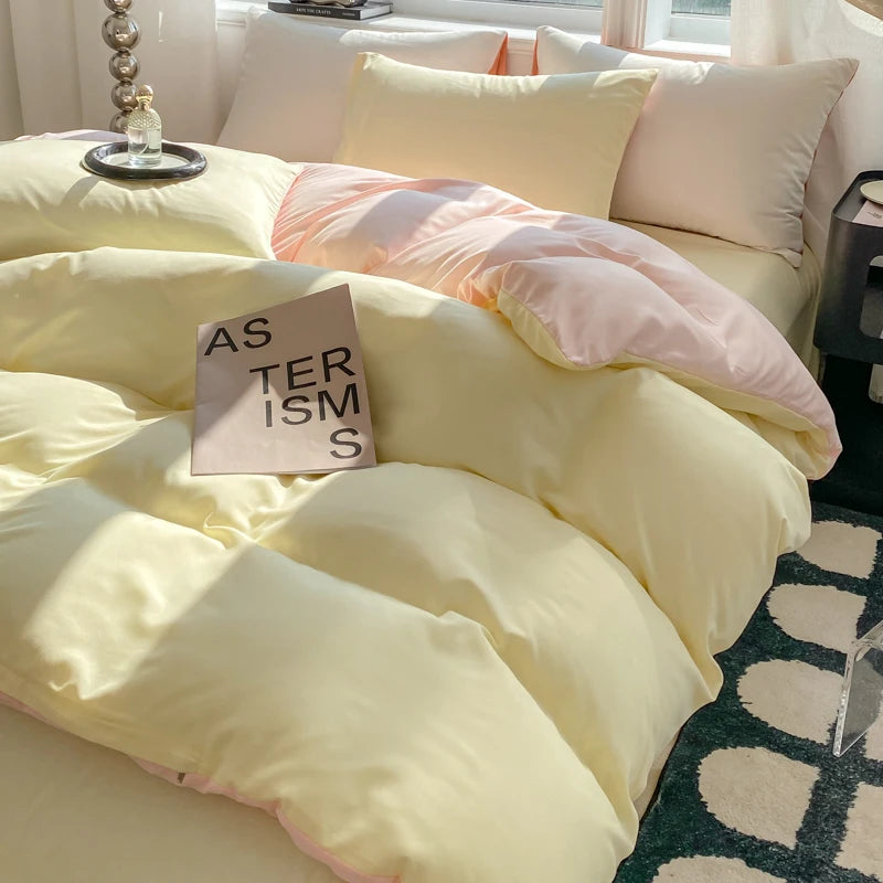 Yellow and pink bedding on a bed with a small sign reading 'AS TERISMS' in a room.