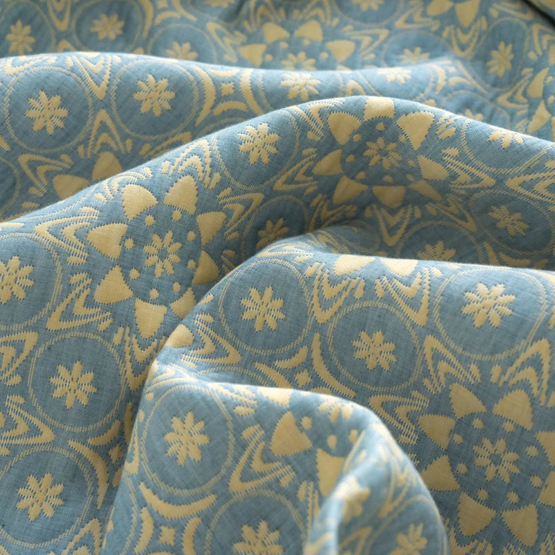 Close-up of blue fabric with yellow geometric pattern