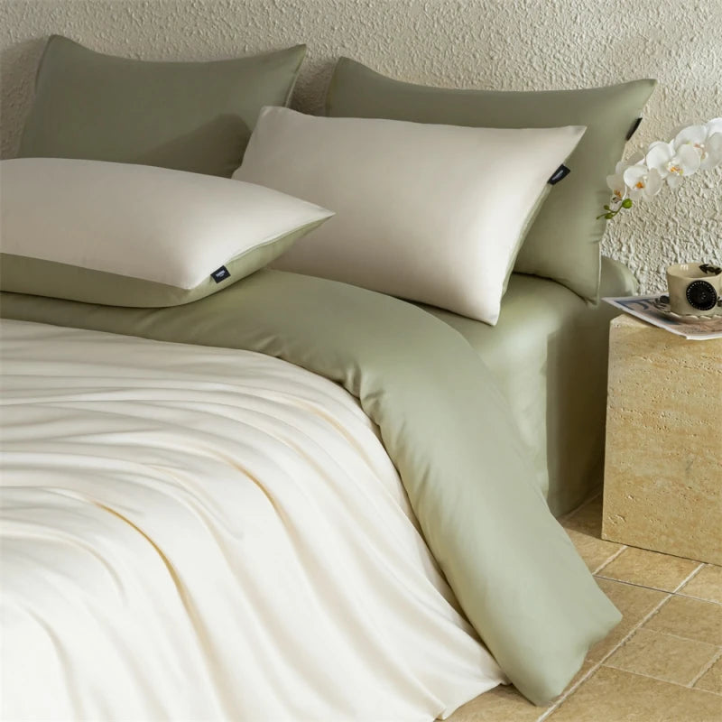 Neatly made bed with light green bedding and pillows in a bedroom setting.