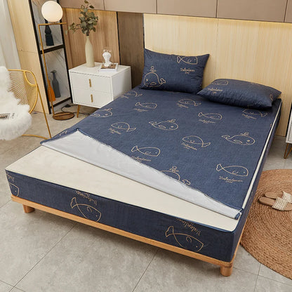 Blue mattress cover with whale pattern on a bed in a bedroom setting
