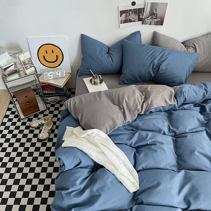 Bedroom with blue bedding and gray pillows on a checkered floor.