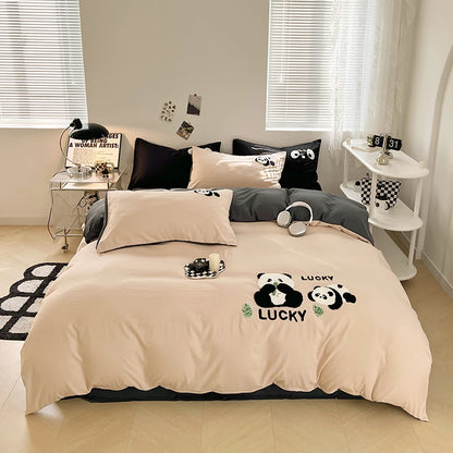 Beige bedding set with panda design on a bed in a bedroom.