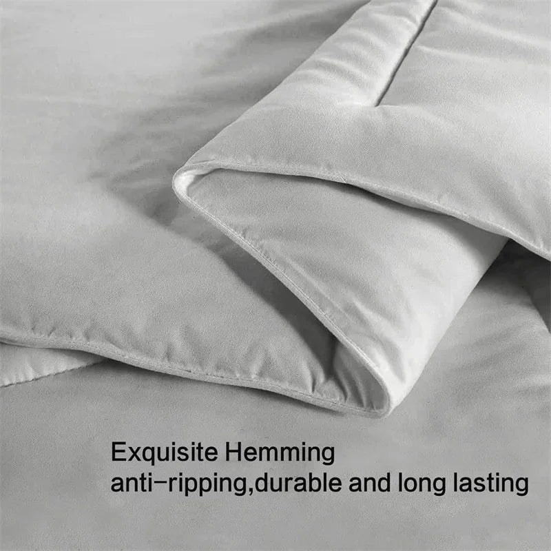 Gray bedding set with 'Exquisite Hemming' text on a light gray background