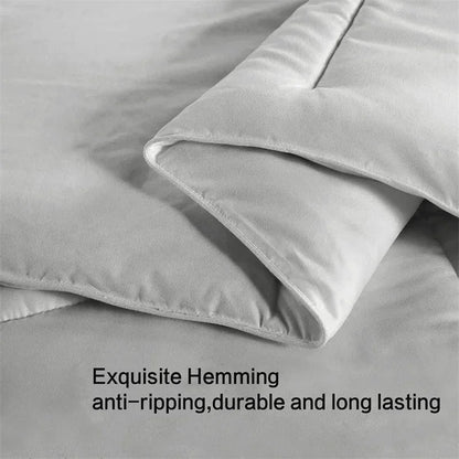 Gray bedding set with 'Exquisite Hemming' text on a light gray background