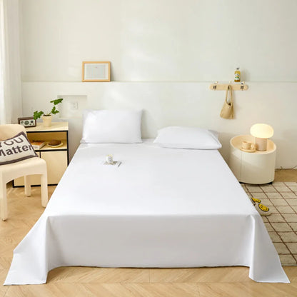 Minimalist bedroom with a neatly made bed, side tables, and decor items.