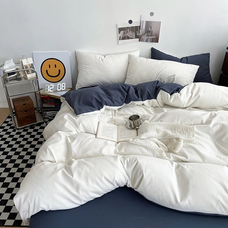 Bed with white comforter and blue pillows, nightstand with clock and books, checkered floor.