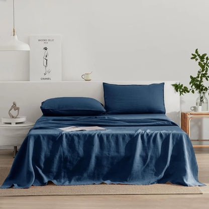Blue bedding set on a bed in a bedroom with decor elements.