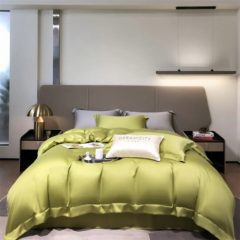Bedroom with green bedding and gray headboard