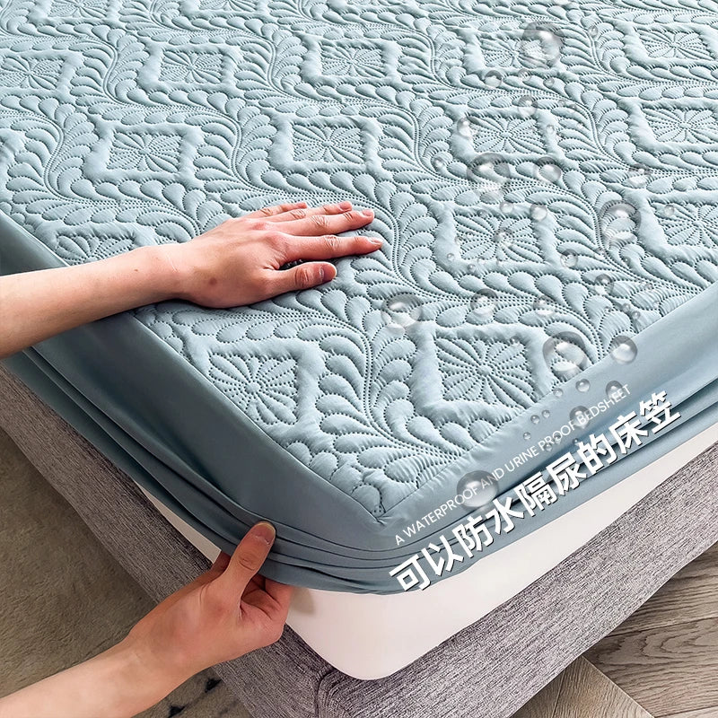 Person holding a textured mattress pad with floral patterns and water droplets on a bed.