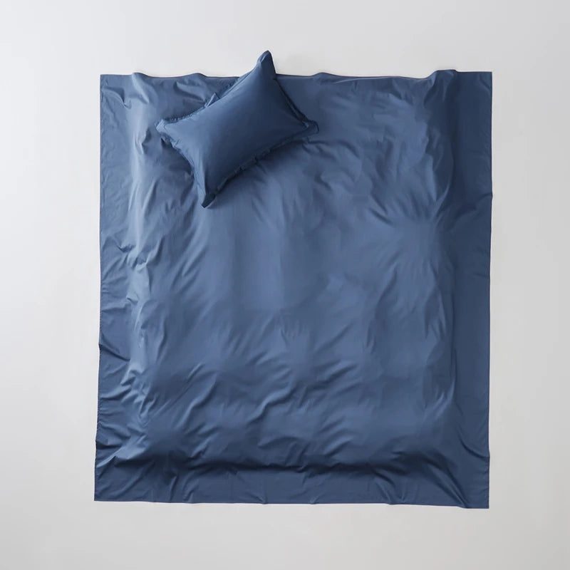 Blue bedding set with a pillow on a white background