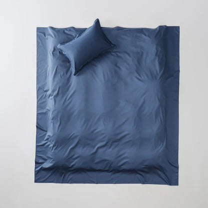 Blue bedding set with a pillow on a white background