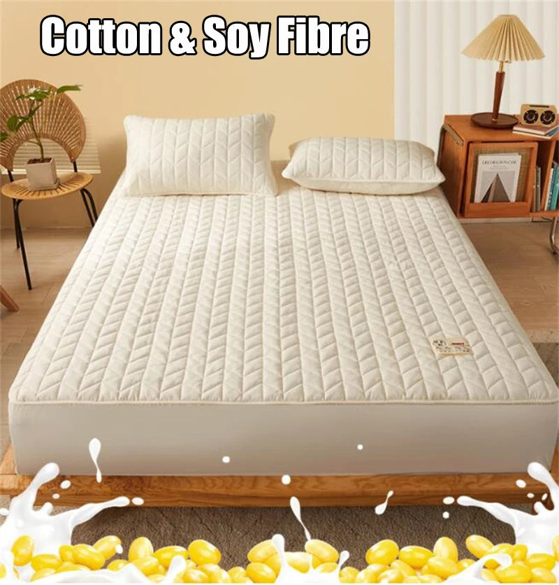 Mattress protector on a bed with 'Cotton & Soy Fibre' text above.