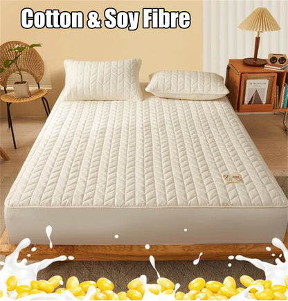 Mattress protector on a bed with 'Cotton & Soy Fibre' text above.
