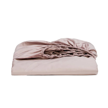 Folded pink fitted sheet on a white background