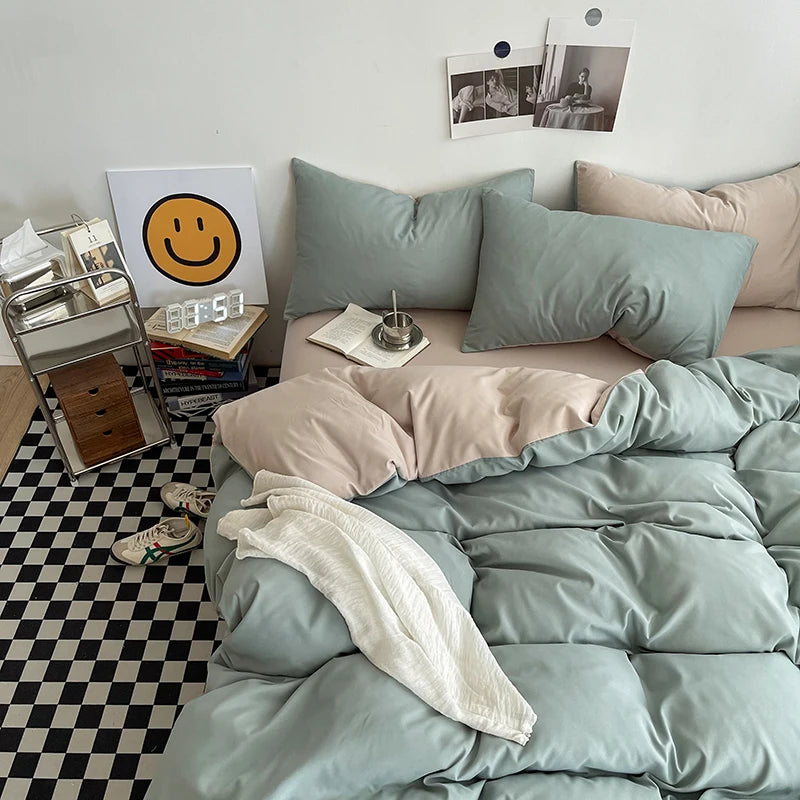 Bedroom with light green bedding and pillows on a bed, checkered floor, and wall decor.