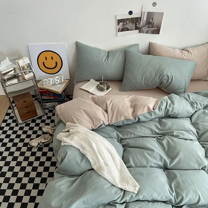 Bedroom with light green bedding and pillows on a bed, checkered floor, and wall decor.