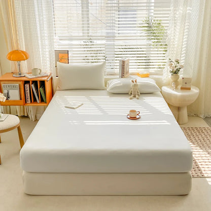 Bed with white mattress cover in a bright bedroom