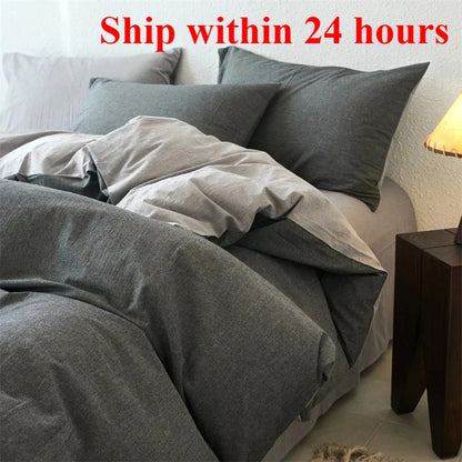 Gray bedding set on a bed with pillows and a nightstand in a bedroom.