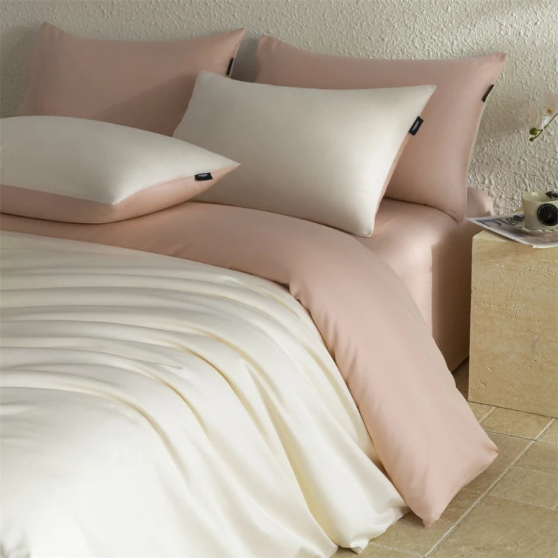 Bed with pink and beige bedding and pillows on a tiled floor.